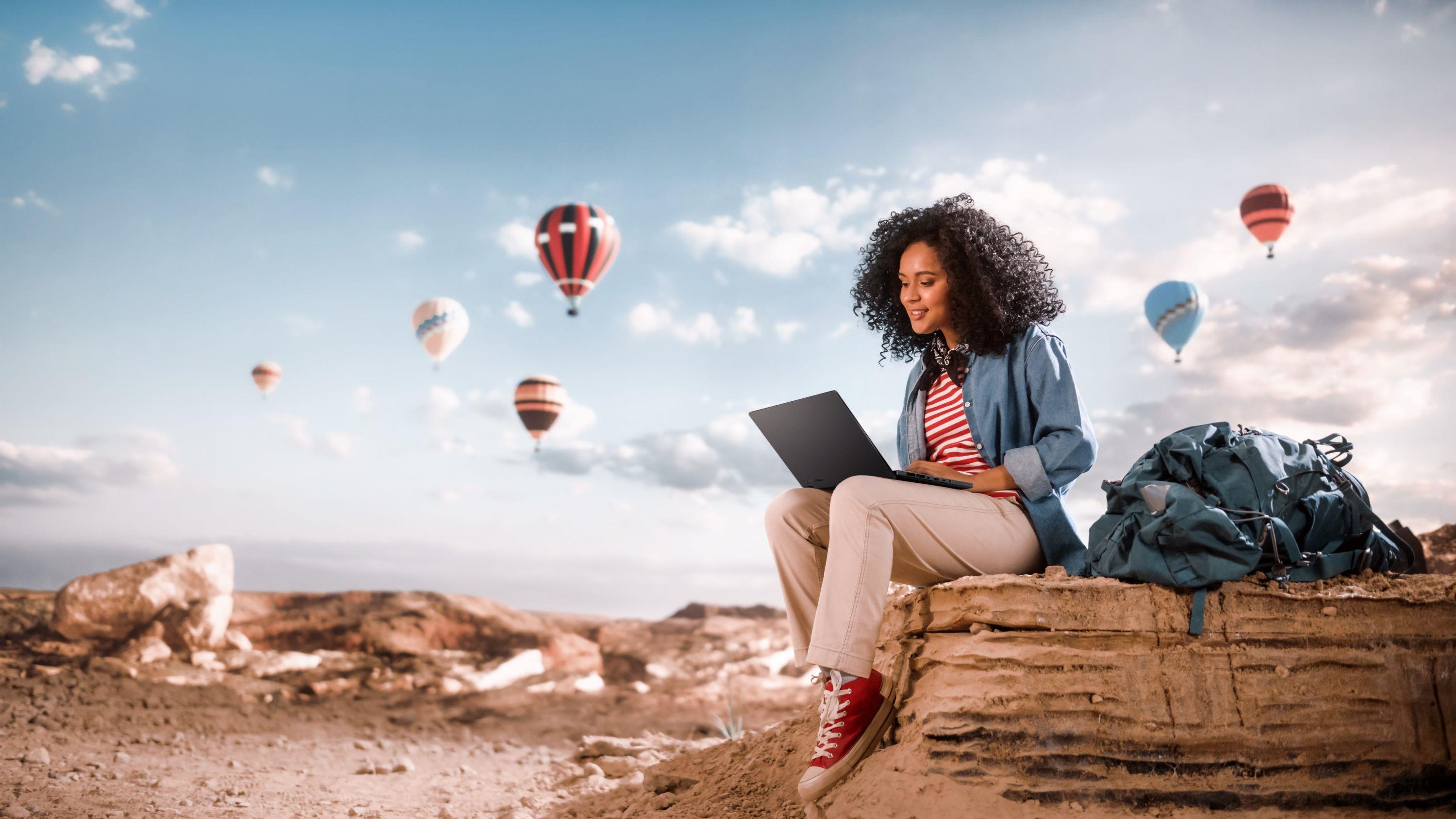 A woman sitting with an ASUS laptop