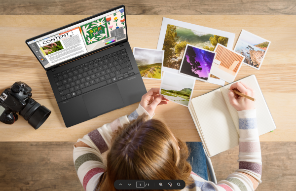 A person using an ASUS laptop for photography journaling