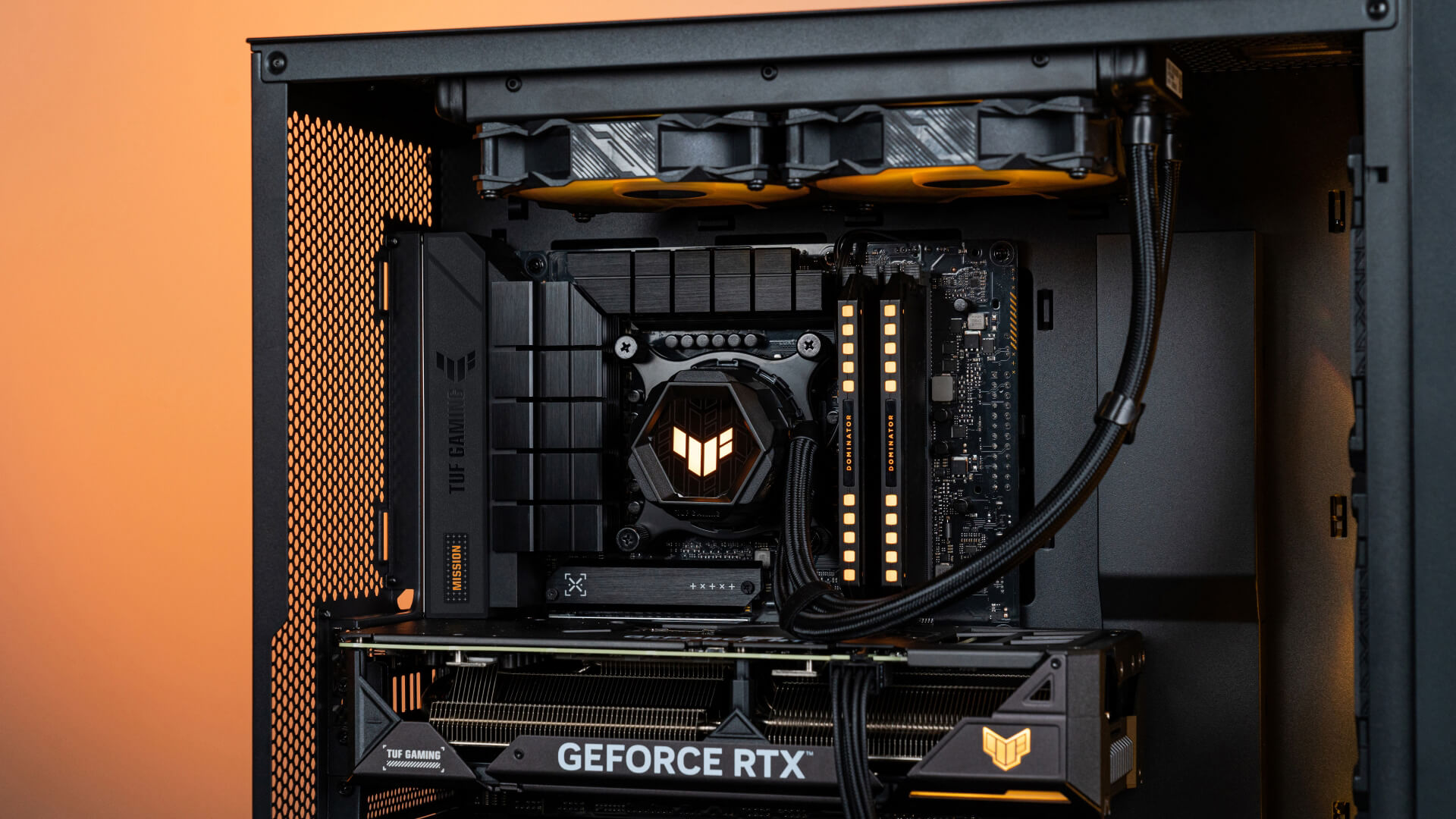 A top part of BTF PC build with orange lighting effect, which shows the VGA’s power cable in the build.